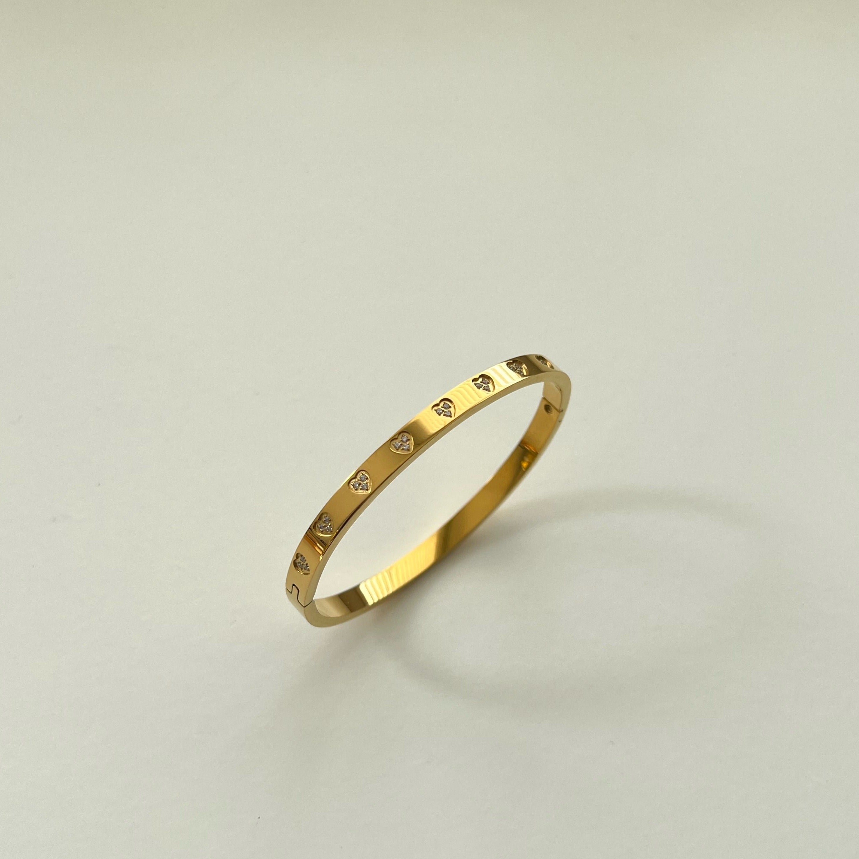 Introducing our Adore Bangle.  18K Stainless Steel Gold Plated Heart Zircon Bangle.  Waterproof Tarnish Free 18cm.