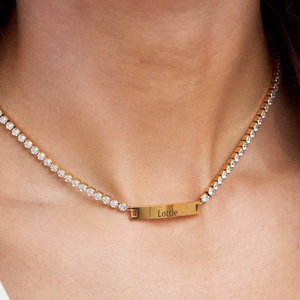 Introducing our Personalised Tennis Necklace, which makes the perfect gift for yourself of your loved one!  Please leave the engraving for your order in the note section in your basket.    Available in Silver & Gold.  Length: 35+5cm.  Material: Zircon & Stainless Steel. 